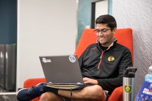 Male student sitting looking at his laptop.