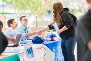 UF student shaking recruiter's hand in a career fair
