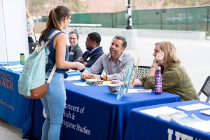 UF student talking to representatives from a UF department in a career fair