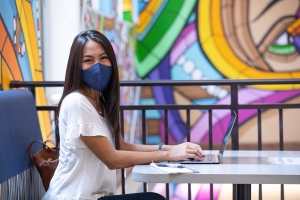UF Student smiling at the camera wearing a mask