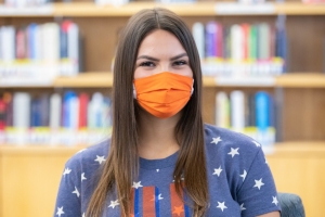 UF student wearing a mask looking directly at the camera