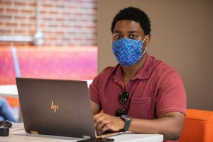 UF student wearing a mask looking directly at the camera.