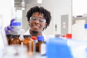 man looking at bottles in a laboratory