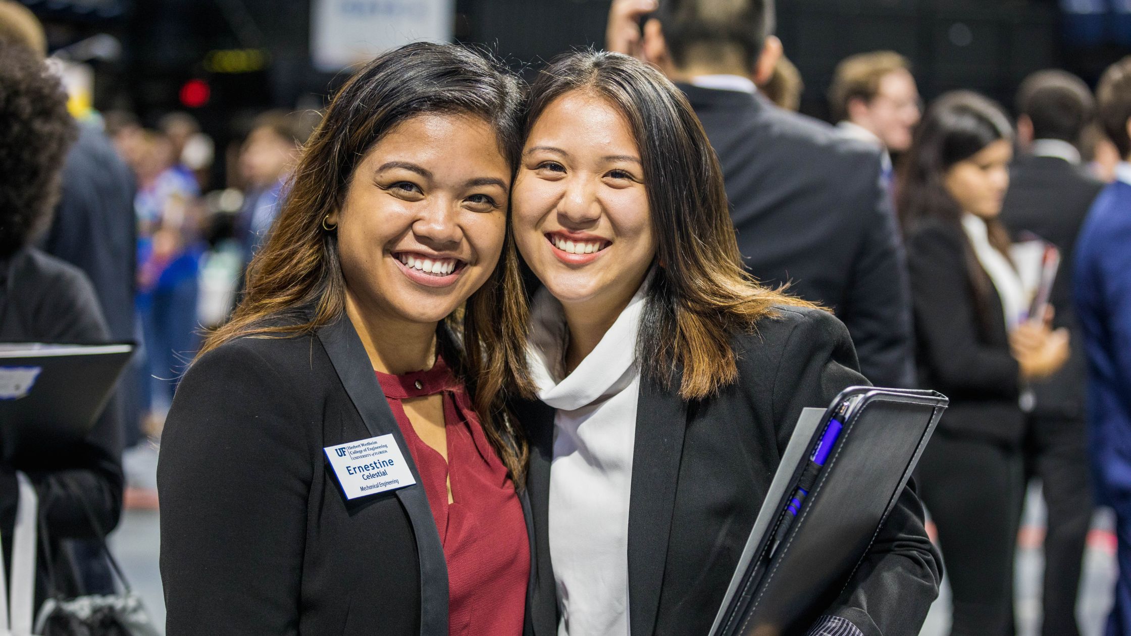 Two attendees smiling for camera at career showcase